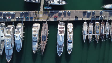 Luxury-Yachts-And-Sailboats-Docked-At-The-Marina-With-Parked-Cars-In-Palma-De-Mallorca,-Spain