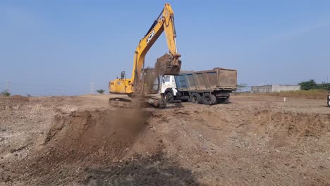 An-excavator-loads-sand-Moorum-into-a-dumper-truck-at-the-construction-site