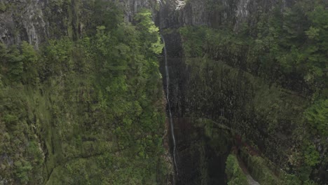 Wide-and-epic-aerial-shot-of-Lagoa-da-Vento-waterfall-in-Madeira