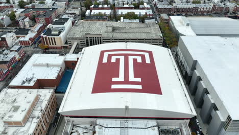 Aerial-tilt-reveals-Temple-T-logo-on-rooftop