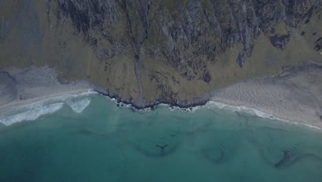 Aerial-view-overlooking-the-Kvalvika-and-Vestervika-beaches,-in-Lofoten,-Norway---high-angle,-pull-back,-drone-shot