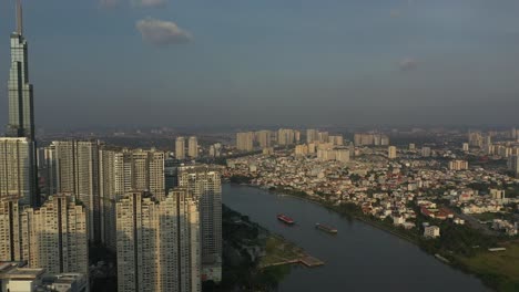 Late-afternoon-view-of-high-rise-development-and-skyscraper-from-drone-with-view-to-city-skyline-and-river