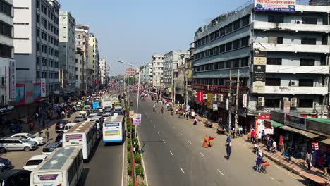 Panning-shot-of-street-of-Mirpur-district,-Old-dhaka-with-view-of-buses-and-people-on-the-street