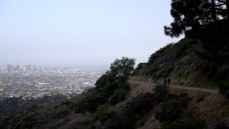 View-of-Los-Angeles-downtown-and-people-hiking-on-the-hills
