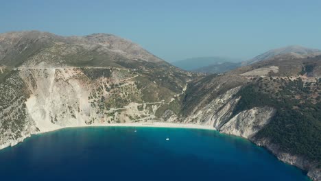 Myrtos-beach,-natural-cliff-bay,-Emerald-sea-in-Kefalonia-island,-Aerial-Pullback