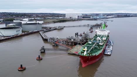 Silver-Rotterdam-oil-petrochemical-shipping-tanker-loading-at-Tranmere-terminal-Liverpool-aerial-dolly-right-slow-shot