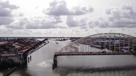 Aerial-View-Of-Opened-Bascule-Bridge-Over-Noord-River-Slowly-Closing-And-Ship-Approaching-Underneath