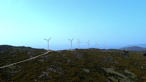 Row-Of-Fast-Spinning-Windfarm-Turbines-In-Hillside-Of-Galicia-In-Spain
