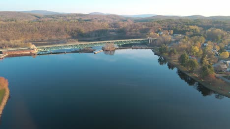 Aerial-fly-in-view-over-a-blue-lake-in-Greenfield,-Massachusetts-in-the-New-England-area