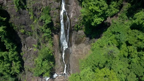 Aerial-shot-of-a-huge-waterfall-surrounded-by-trees-in-a-forest-in-Costa-Rica