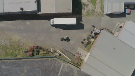 Smooth-decent-over-forklift-loading-truck-from-aerial-perspective-directly-above