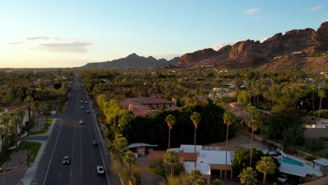 aerial-tilt-up-over-palms-revealing-homes-at-the-base-of-camelback-mountain-near-scottsdale-arizona