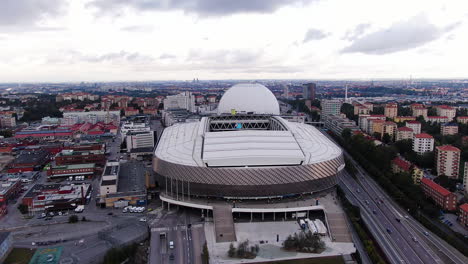 City-buildings-of-Stockholm-with-majestic-arena,-aerial-drone-view