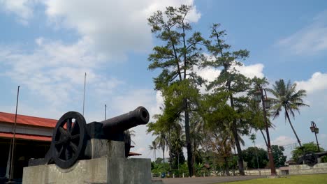 Old-cannon-from-Dutch-colonial-era-in-Indonesia,-pan-down-from-sky