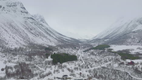 Snowy-Landscape-At-Kåfjord-Town-In-Olderdalen,-Norway-During-Winter---aerial-pullback