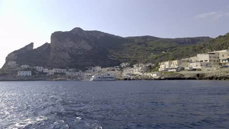 Levanzo-island-and-village-as-seen-from-boat-sailing-on-mediterranean-sea-of-Sicily-in-Italy-clear-crystal-water