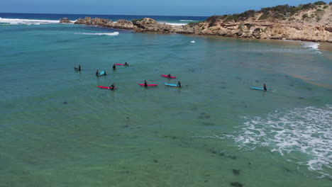 Aerial:-Young-surf-class-waits-for-waves-in-shallow-water-behind-point