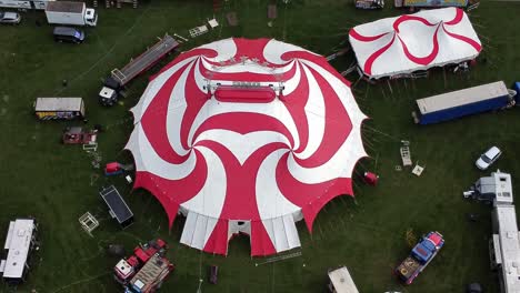Planet-circus-daredevil-entertainment-colourful-swirl-tent-and-caravan-trailer-ring-aerial-orbit-left-top-down-view