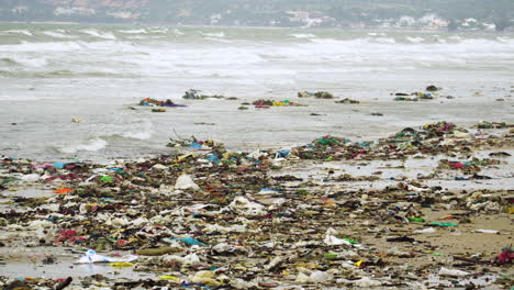 Dirty-polluted-beach-full-of-trash-on-a-gloomy-day
