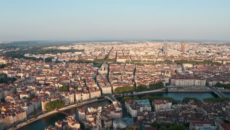 Dolly-forward-drone-shot-over-central-Lyon-city-France-at-sunset