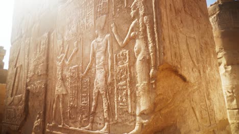 Close-up-of-intricate-carvings-in-the-stone-of-a-pillar-in-Karnak-Temple,-Luxor-Egypt