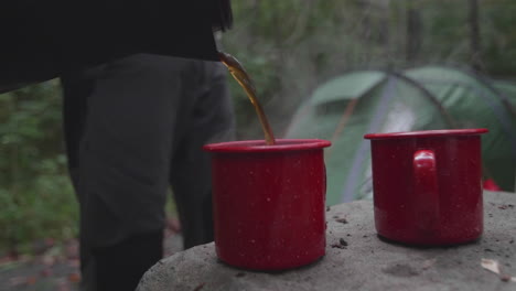 Filling-two-red-camping-coffee-cups