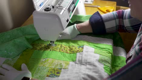 Sewing-a-pattern-on-a-homemade-quilt-with-a-sewing-machine---slow-motion
