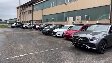 Slow-dolly-shot-of-cars-outside-Carvolution-HQ-in-Bannwil,-Switzerland