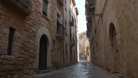 People-Walking-On-Historic-Street-In-Old-Town-Of-Girona-In-Catalonia,-Spain