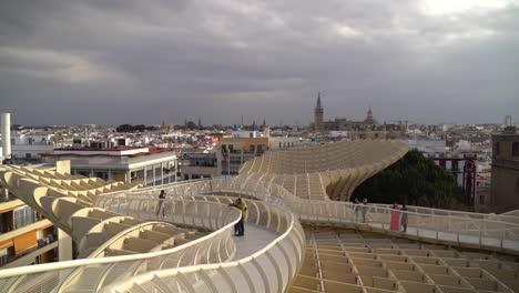 Slow-motion-high-up-pan-on-rooftop-of-Metropol-Parasol-in-Seville,-Spain