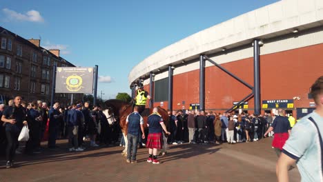 Two-Scottish-supporters-talking-to-a-mounted-police-officer