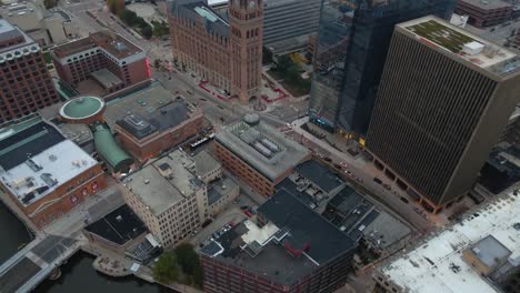 Aerial-view-overlooking-roof-and-buildings-in-Milwaukee,-USA---tilt,-drone-shot