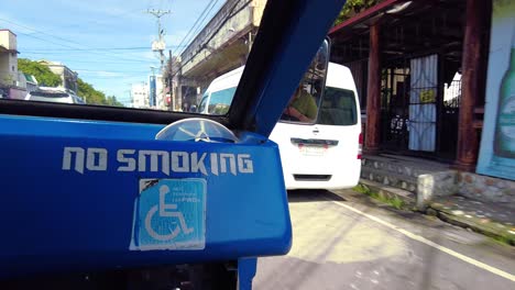 A-passenger-side-ride-on-a-Jeepney-for-public-transportation