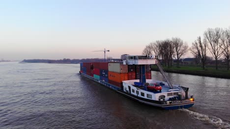 Aerial-View-Of-Juliam-Cargo-Freighter-Travelling-Along-Oude-Maas