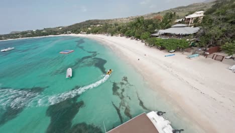 Beachfront-Luxury-Villas,-White-Beach-Sand-and-Shallow-Blue-Waters-at-Playa-La-Ensenada-Caribbean-Resort---Drone-Fly-over-fpv-loop-shot