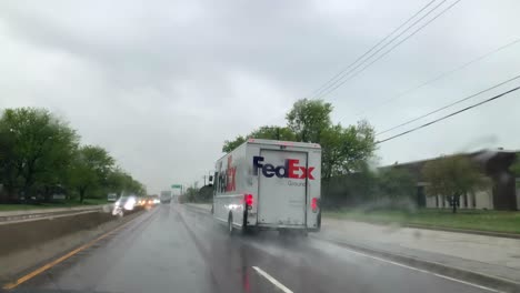 FedEx-Ground-driving-by-on-a-rainy-road-in-motion