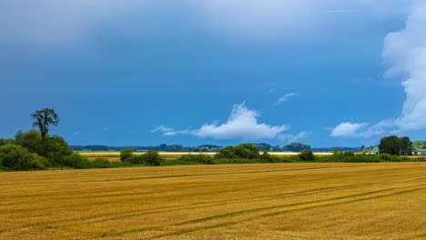 Fleeting-clouds-in-blue-sky-move-over-freshly-harvested-farmland