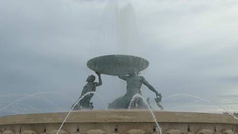 Triton-Fountain-in-front-of-the-Valletta-Fortress-in-Malta-with-cloudy-sky-and-low-contrast