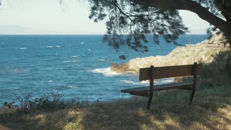 Bench-sitting-empty-by-rough-sea-of-Lesvos-Island-Greece