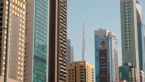 Dubai-handheld-camera,-Burj-Khalifa-and-Skyscrapers,-sunny-day,-UAE
