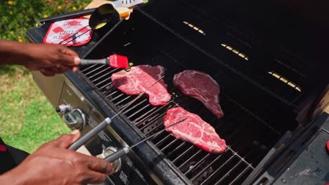 Delicious-slices-of-barbecuing-steak-on-a-grill