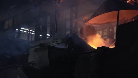 industrial-safety-first-concept,-casting-foundry,-Worker-controlling-metal-melting-in-furnaces