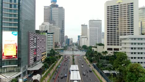 Majestic-downtown-of-Jakarta-with-skyscrapers-and-heavy-traffic,-aerial-drone-shot