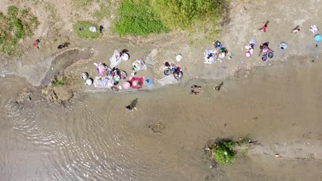 Children-playing-on-shore-while-women-wash-clothes-in-Massacre-river-waters