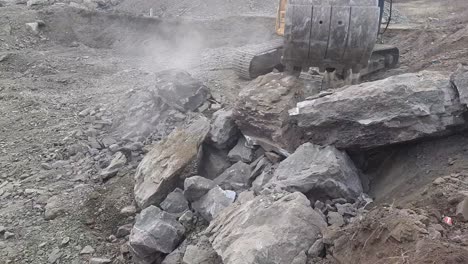 Excavator's-arm-picks-up-the-big-rocks