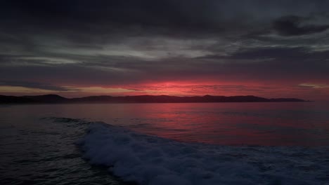 Dramatic-Sunset-Sky-And-Ocean-Waves-In-Spirits-Bay,-New-Zealand---drone-static