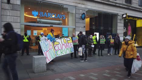 A-man-talking-to-a-climate-change-protester-outside-a-bank