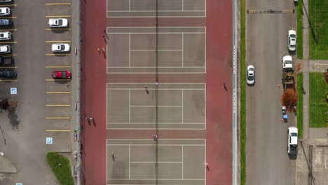 Top-View-Of-People-Playing-Tennis-On-Outdoor-Tennis-Courts-On-A-Sunny-Day