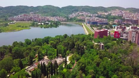 Flying-over-the-beautiful-Artificial-Lake-of-Grand-Park-in-Tirana,-Albania