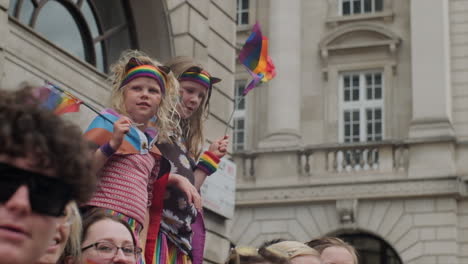 Young-children-flying-rainbow-flags-at-a-pride-event-slow-motion
